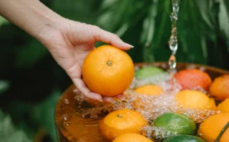 Crop anonymous female washing juicy - Credits: pexels